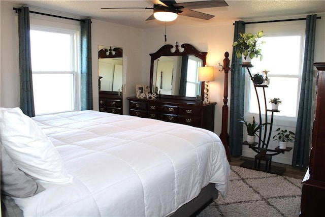 bedroom with a ceiling fan and crown molding