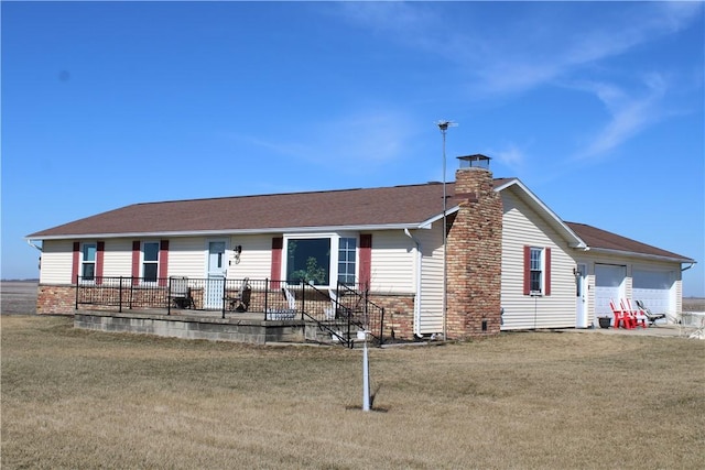 ranch-style house with a front yard, a garage, and a chimney