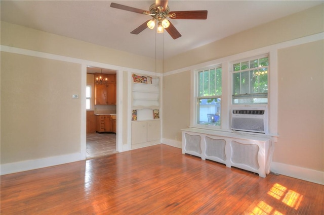 1416 W Decatur St, Decatur, IL 62522 - unfurnished room featuring wood finished floors, a ceiling fan, baseboards, and cooling unit