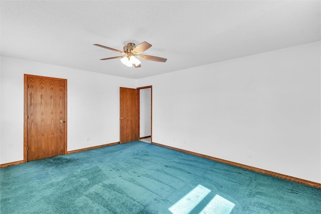 carpeted spare room with ceiling fan