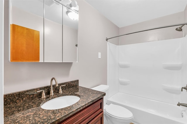 full bathroom featuring shower / bathing tub combination, vanity, and toilet