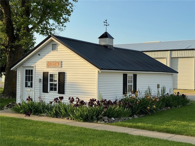 view of property exterior with a lawn