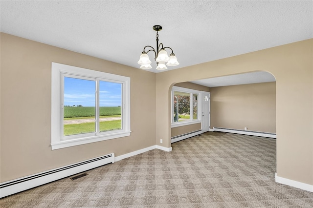 carpeted empty room with a textured ceiling, a notable chandelier, and baseboard heating