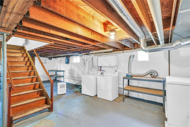 basement with a healthy amount of sunlight and independent washer and dryer