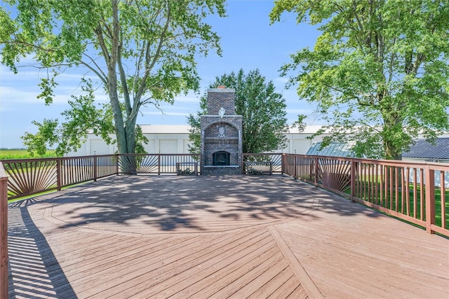 wooden terrace featuring an outdoor brick fireplace