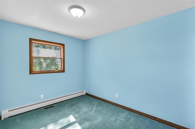 carpeted empty room with a textured ceiling and a baseboard heating unit