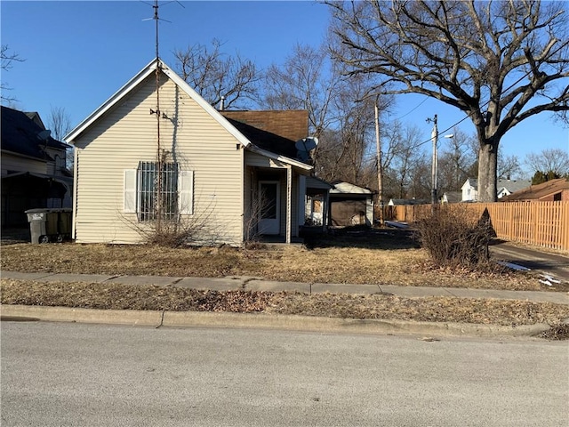 view of property exterior featuring fence