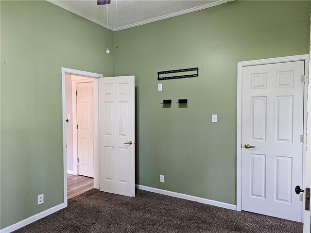 301 S Meridian St, Toledo, IL 62468 - unfurnished bedroom featuring dark carpet and ornamental molding