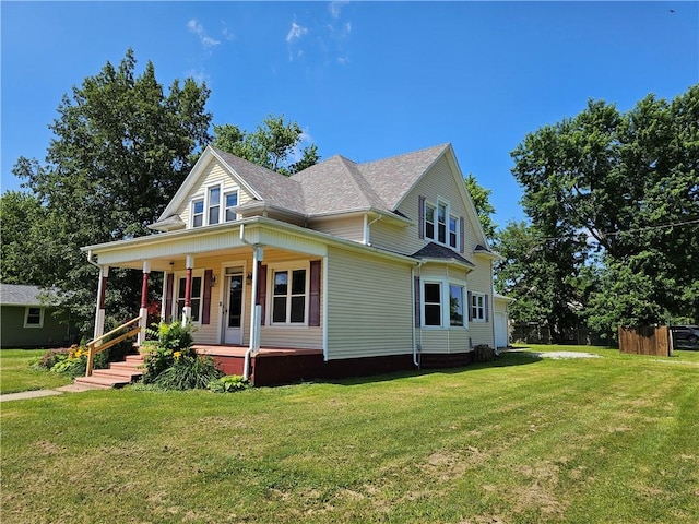 301 S Meridian St, Toledo, IL 62468 - view of front of house with a porch, a front yard, and a shingled roof