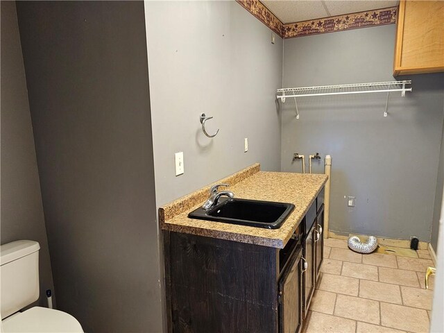 301 S Meridian St, Toledo, IL 62468 - washroom with a sink and light tile patterned flooring