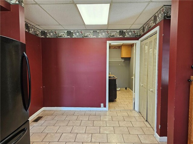 301 S Meridian St, Toledo, IL 62468 - unfurnished dining area with a paneled ceiling and baseboards
