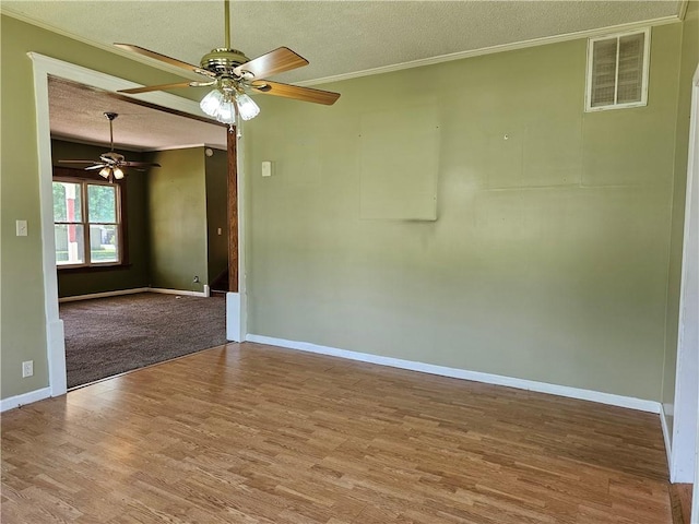 301 S Meridian St, Toledo, IL 62468 - empty room featuring a textured ceiling, wood finished floors, a ceiling fan, and ornamental molding