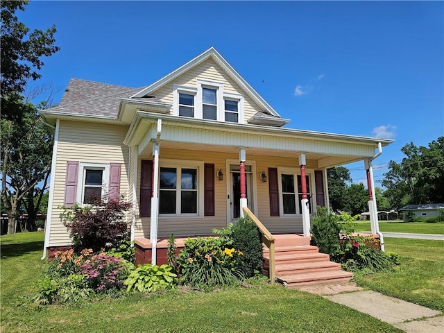 301 S Meridian St, Toledo, IL 62468 - bungalow-style home featuring a porch, a front yard, and a shingled roof