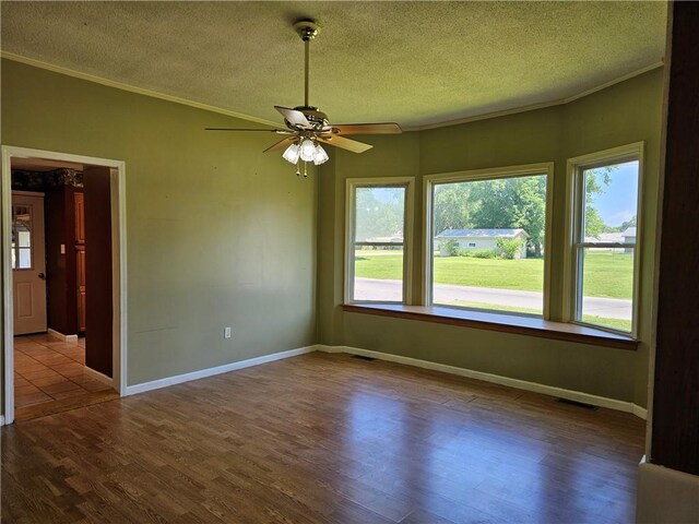 301 S Meridian St, Toledo, IL 62468 - empty room with crown molding, a textured ceiling, dark wood-style floors, and a ceiling fan