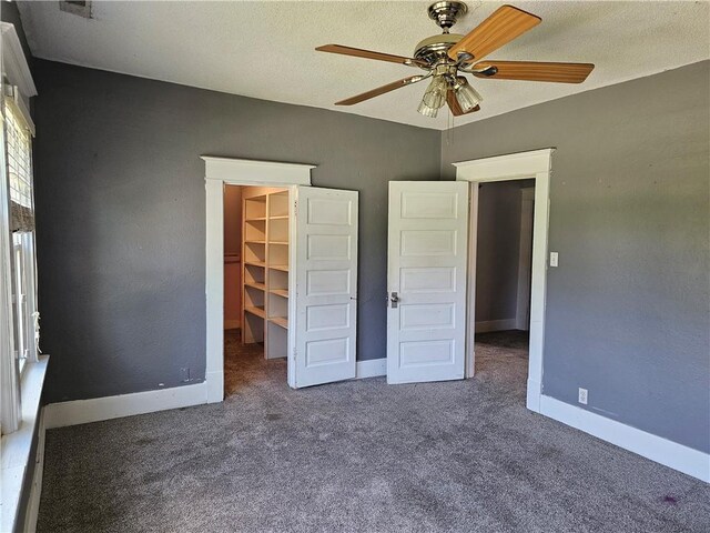 301 S Meridian St, Toledo, IL 62468 - unfurnished bedroom with a spacious closet, carpet flooring, ceiling fan, and a closet