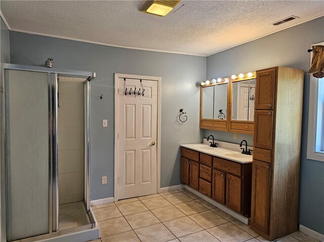 301 S Meridian St, Toledo, IL 62468 - full bath featuring a textured ceiling, double vanity, a shower stall, tile patterned flooring, and crown molding