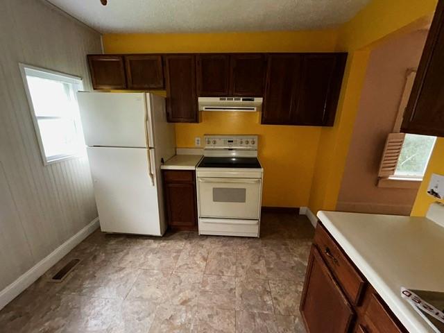 1010 N Summit Ave, Decatur, IL 62522 - kitchen featuring white appliances, extractor fan, light countertops, and dark brown cabinetry