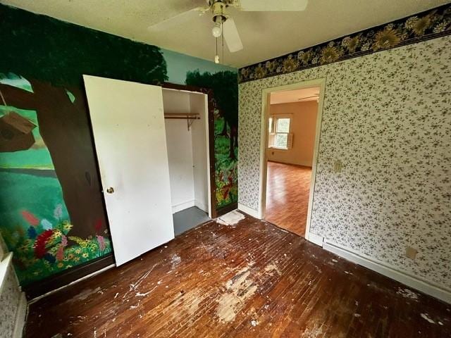 1010 N Summit Ave, Decatur, IL 62522 - unfurnished bedroom featuring wood finished floors, wallpapered walls, a closet, and ceiling fan