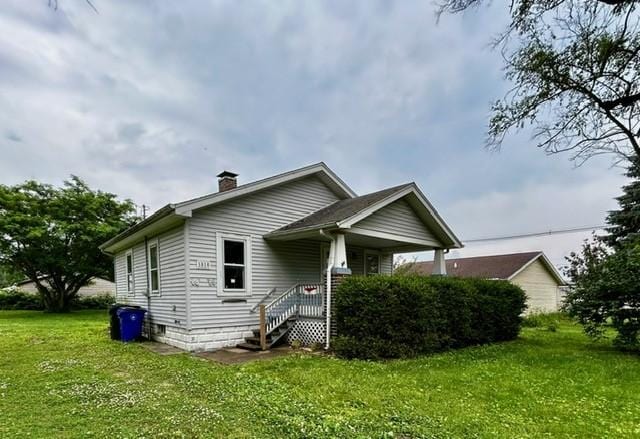 1010 N Summit Ave, Decatur, IL 62522 - view of property exterior with a yard and a chimney