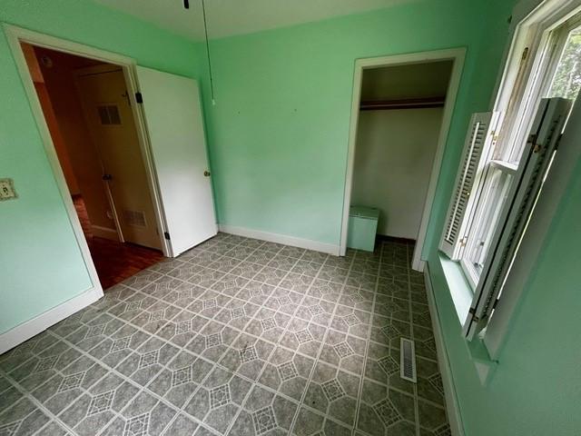 1010 N Summit Ave, Decatur, IL 62522 - unfurnished bedroom with a closet and tile patterned floors