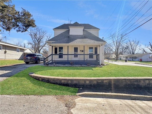 bungalow-style house with a porch, driveway, a shingled roof, and a front lawn