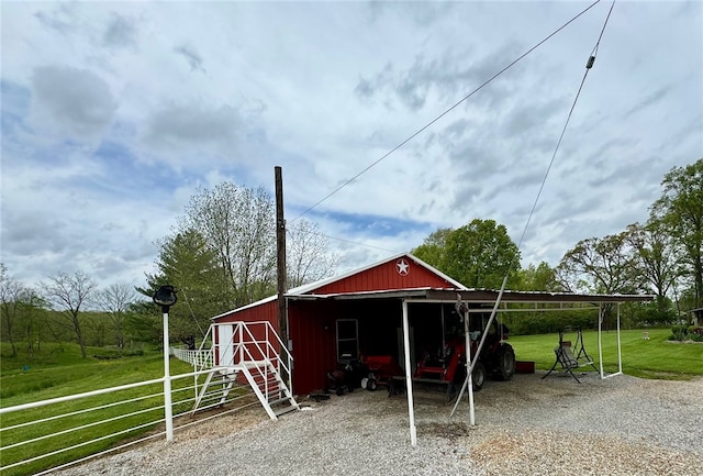 view of outdoor structure featuring a lawn and a carport