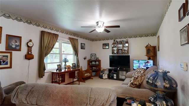 carpeted living room with ceiling fan