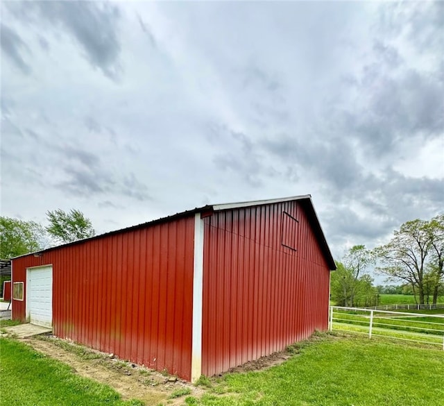 view of outbuilding featuring a yard