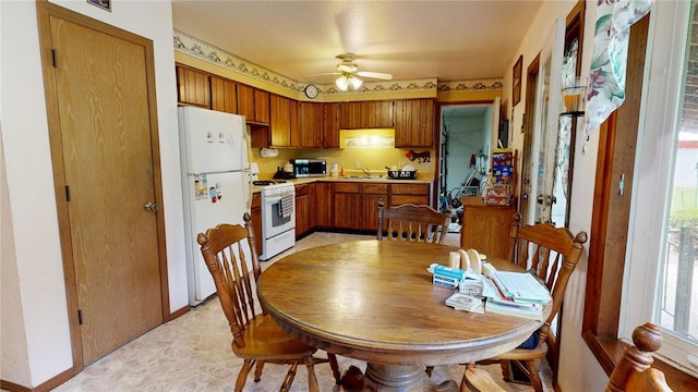 kitchen with white appliances, ceiling fan, and sink