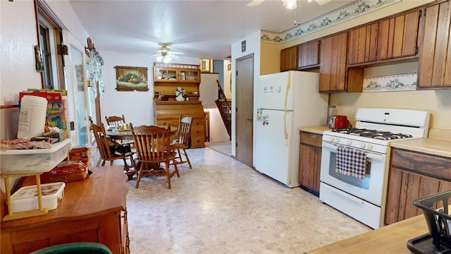 kitchen featuring ceiling fan and white appliances