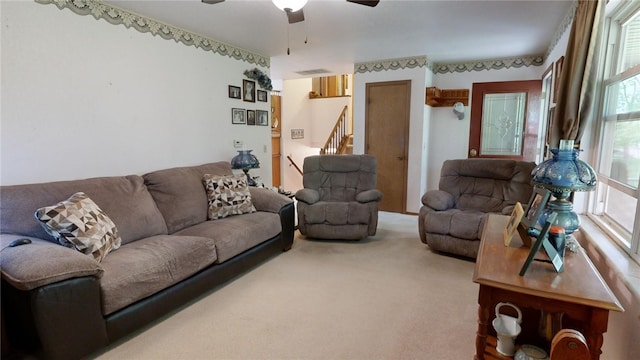 carpeted living room featuring ceiling fan