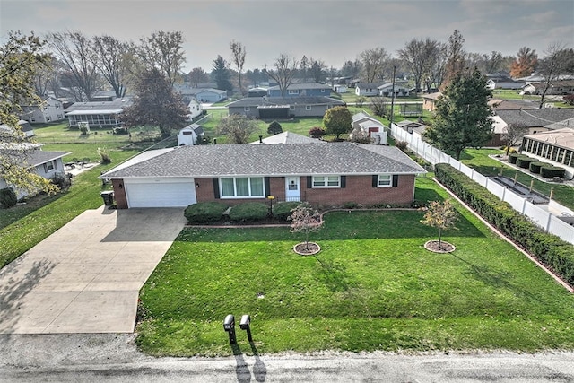 single story home with a front yard and a garage