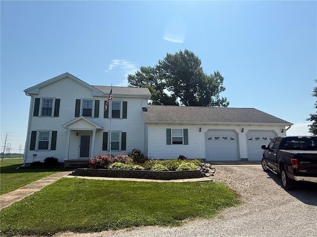 27288 State Highway 16, Ashmore, IL 61912 - colonial inspired home featuring a garage, gravel driveway, and a front yard