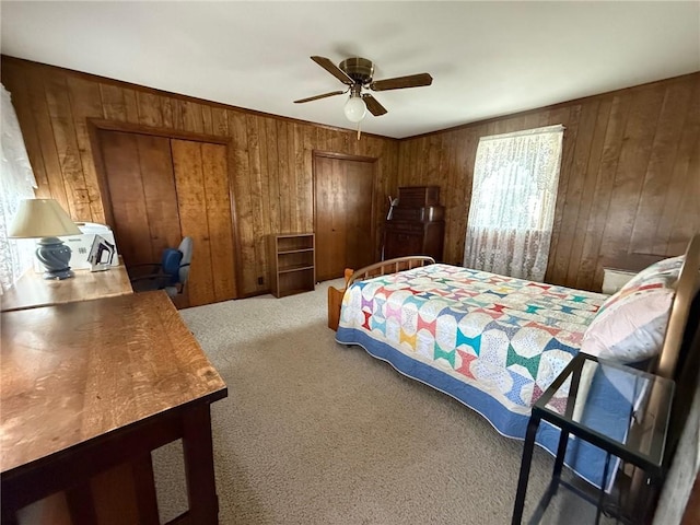 27288 State Highway 16, Ashmore, IL 61912 - bedroom featuring wood walls, carpet flooring, multiple closets, and a ceiling fan