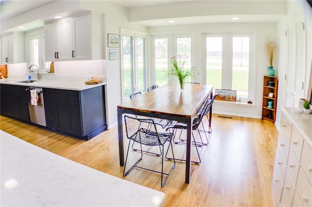 400 Country Club Rd, Mattoon, IL 61938 - kitchen with dishwasher, light wood-style flooring, light countertops, white cabinets, and recessed lighting