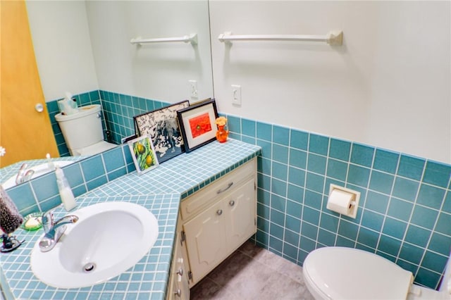 400 Country Club Rd, Mattoon, IL 61938 - half bathroom featuring vanity, tile walls, tile patterned flooring, and wainscoting