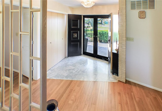 400 Country Club Rd, Mattoon, IL 61938 - foyer entrance featuring french doors, wood finished floors, and a chandelier