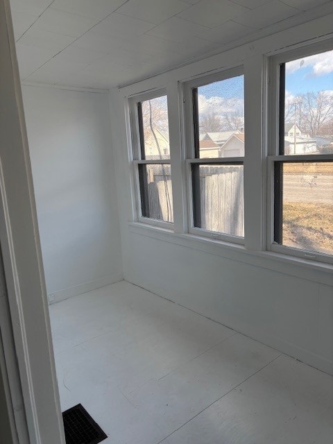 unfurnished room featuring plenty of natural light