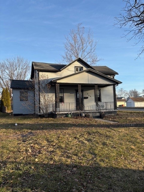 view of front of house featuring covered porch and a front lawn