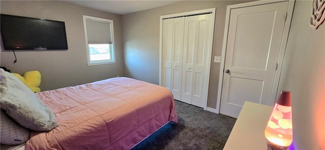 bedroom with a closet and dark carpet