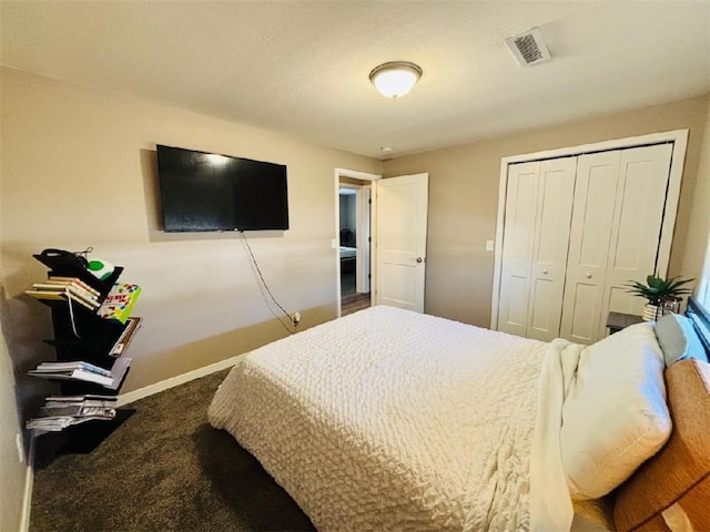 bedroom with carpet floors, a closet, visible vents, and baseboards