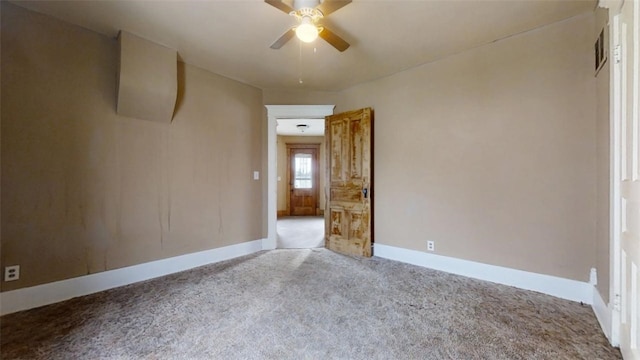 empty room featuring light carpet, ceiling fan, and baseboards