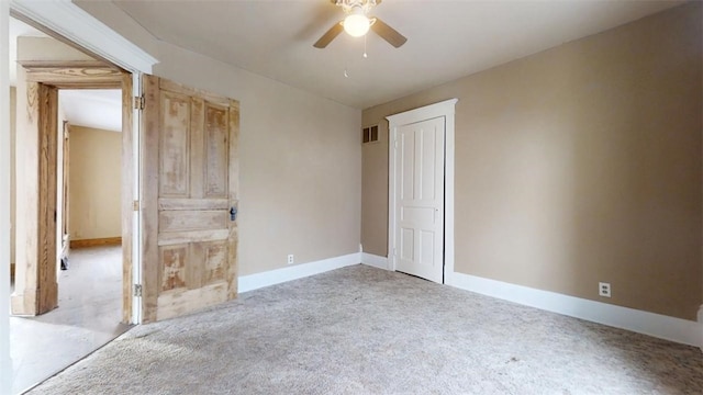 unfurnished bedroom featuring visible vents, baseboards, a ceiling fan, and light colored carpet