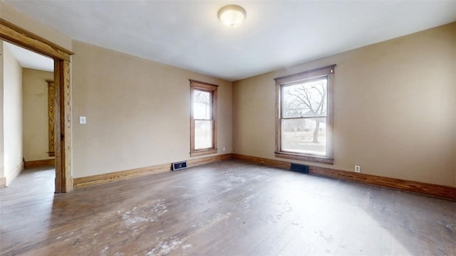 spare room featuring visible vents and baseboards