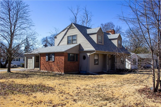 view of home's exterior with driveway, a chimney, roof with shingles, an attached garage, and brick siding