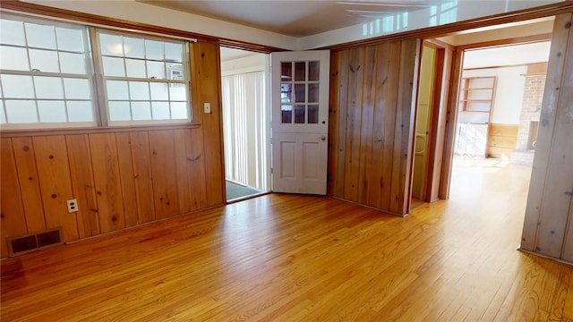 interior space with visible vents, wooden walls, and wood finished floors