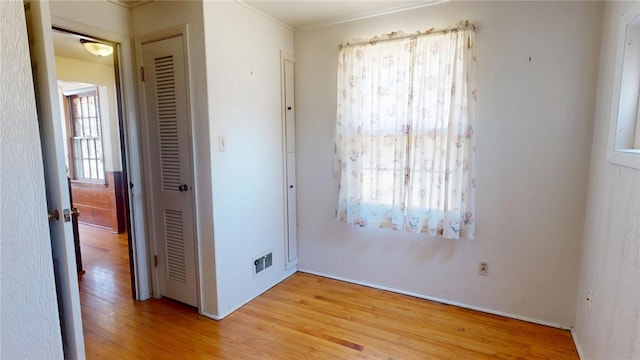 empty room with visible vents and light wood-style floors