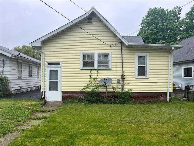 rear view of house with a lawn