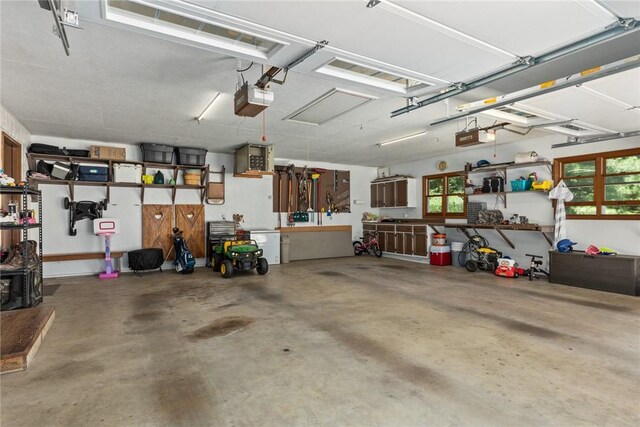 18058 E 1545th Ave, Teutopolis, IL 62467 - garage featuring a garage door opener and a workshop area