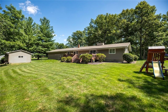 18058 E 1545th Ave, Teutopolis, IL 62467 - rear view of house featuring a playground, a yard, a deck, and crawl space
